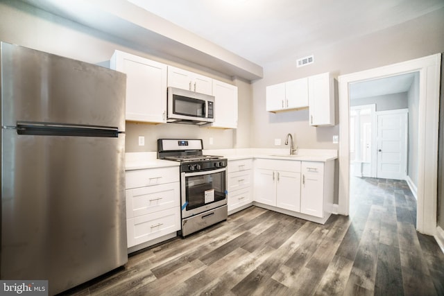 kitchen featuring light countertops, white cabinetry, visible vents, stainless steel appliances, and a sink