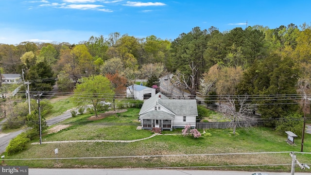 birds eye view of property featuring a view of trees