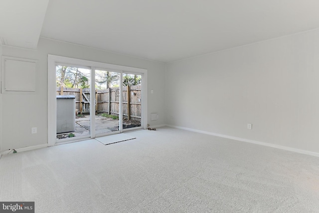 spare room featuring baseboards and carpet flooring