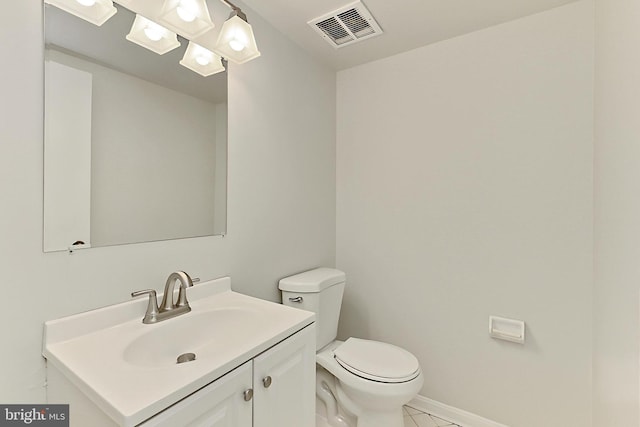 bathroom featuring tile patterned flooring, visible vents, toilet, vanity, and baseboards
