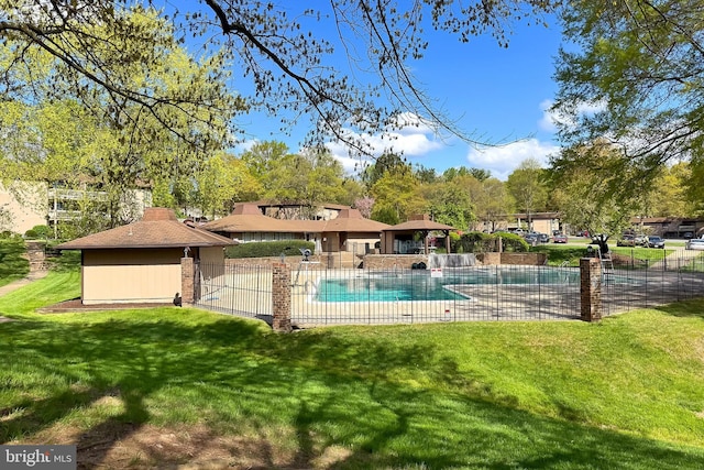 community pool featuring fence and a yard
