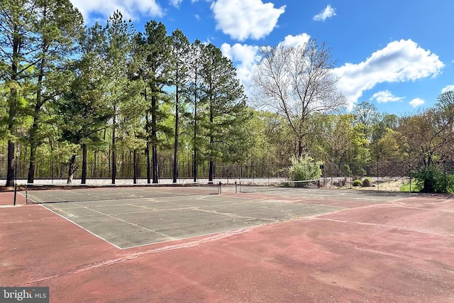 view of sport court featuring fence