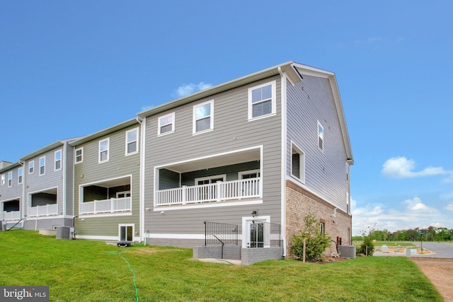6647 Camden St, Middle River, MD 21220 - back of property featuring central air condition unit, brick siding, and a yard