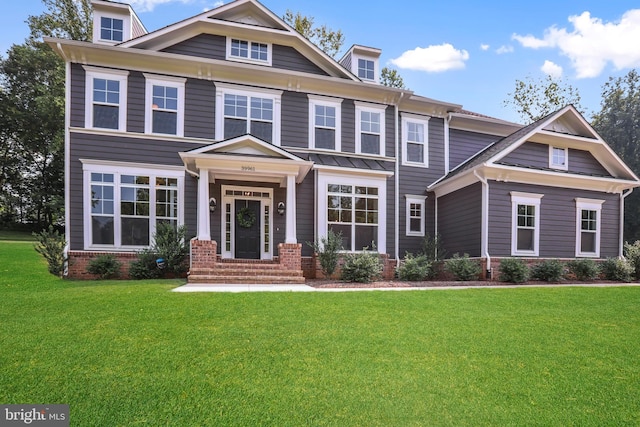 view of front facade featuring brick siding and a front yard