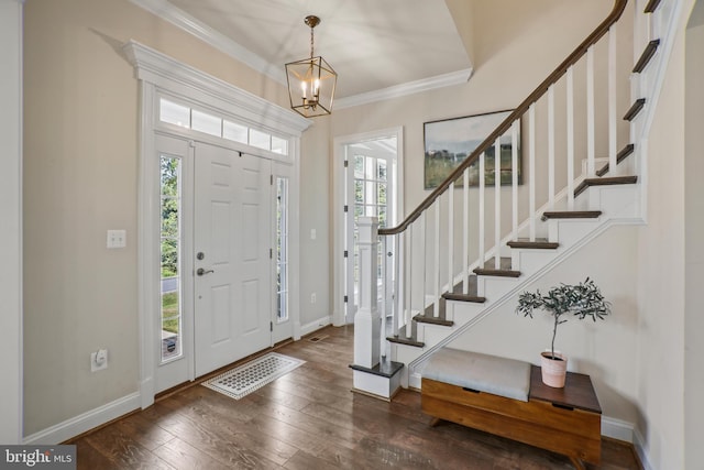 foyer entrance with stairway, visible vents, ornamental molding, baseboards, and hardwood / wood-style flooring