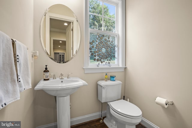bathroom featuring wood finished floors, toilet, and baseboards