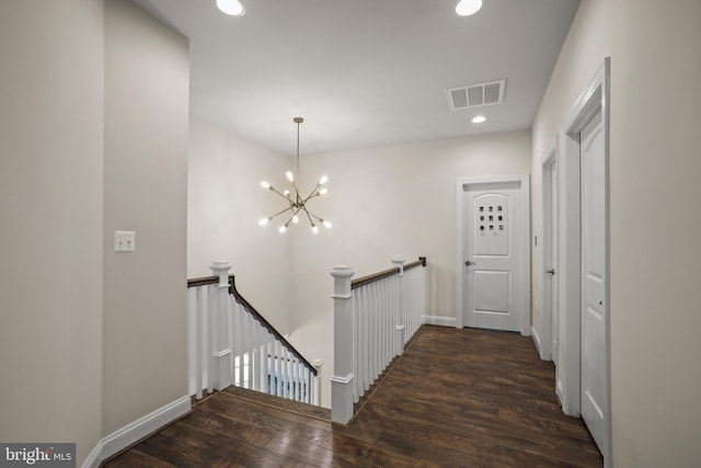 hall with visible vents, recessed lighting, a chandelier, an upstairs landing, and wood finished floors