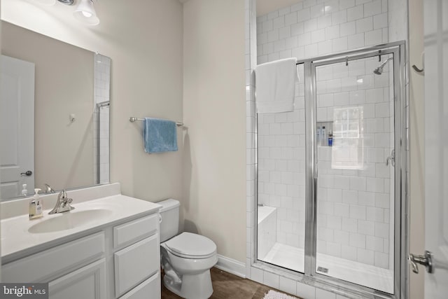 full bath with vanity, toilet, and a stall shower