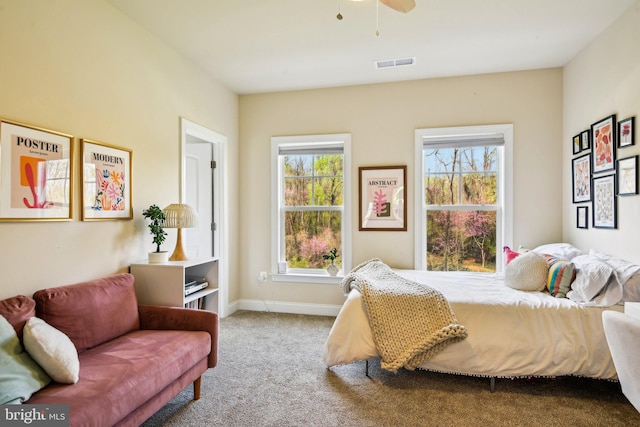 bedroom featuring ceiling fan, carpet floors, visible vents, and baseboards