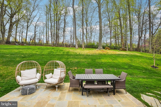 view of yard with a fenced backyard, a patio, and outdoor dining area