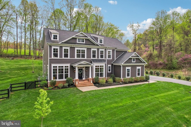 view of front facade featuring a front lawn and fence