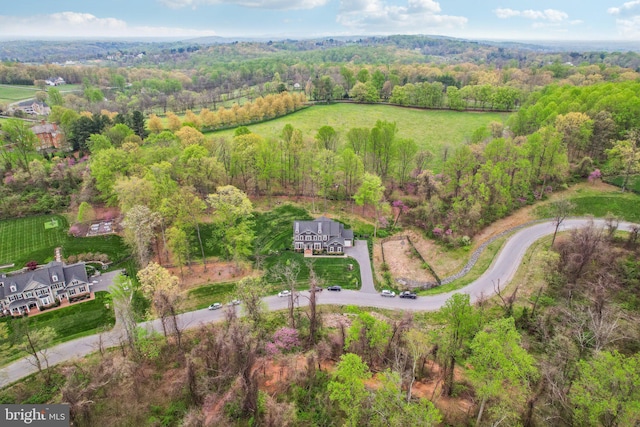 drone / aerial view featuring a forest view