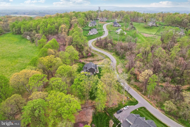 birds eye view of property featuring a wooded view