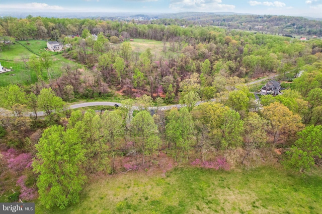 aerial view featuring a wooded view
