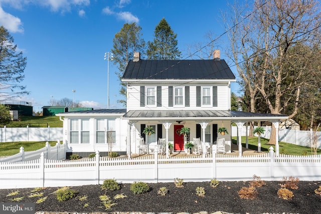 548 Uniontown Rd, Westminster, MD 21158 - back of property featuring metal roof, covered porch, a standing seam roof, and a fenced front yard