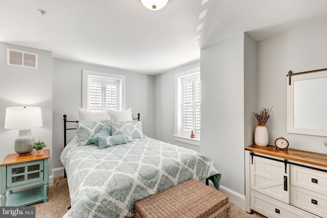 548 Uniontown Rd, Westminster, MD 21158 - bedroom with visible vents, baseboards, carpet, and a barn door