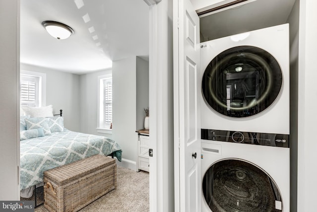 548 Uniontown Rd, Westminster, MD 21158 - clothes washing area with carpet floors, laundry area, baseboards, and stacked washer and clothes dryer