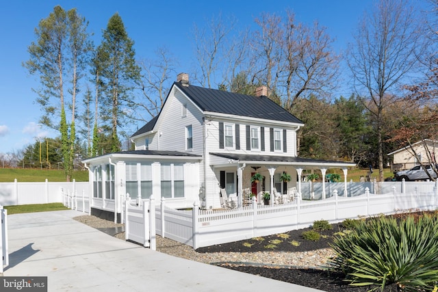 548 Uniontown Rd, Westminster, MD 21158 - view of front of house with a fenced front yard, covered porch, driveway, and a chimney