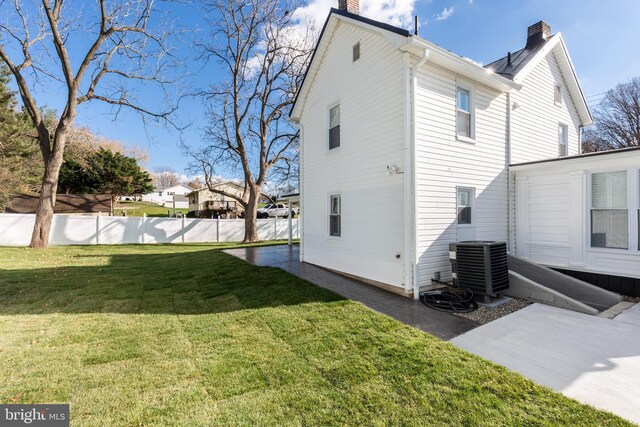 548 Uniontown Rd, Westminster, MD 21158 - rear view of house featuring fence, a yard, central air condition unit, and a chimney