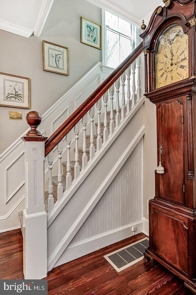 213 Pine Tree Rd, Wayne, PA 19087 - staircase featuring wood finished floors, a decorative wall, wainscoting, and crown molding