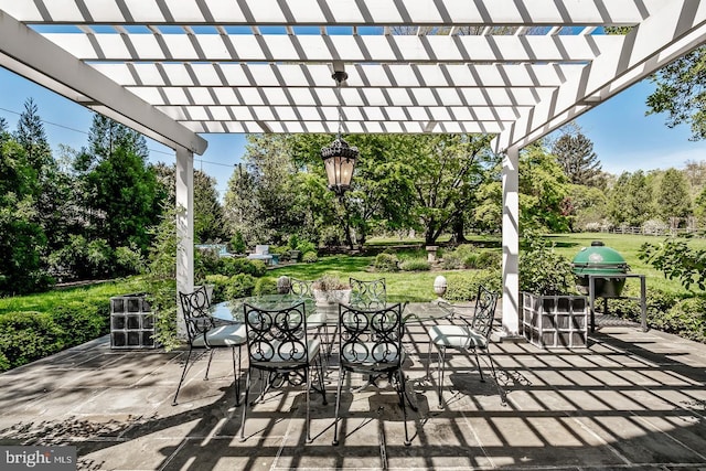 213 Pine Tree Rd, Wayne, PA 19087 - view of patio with outdoor dining area, view of wooded area, a grill, and a pergola