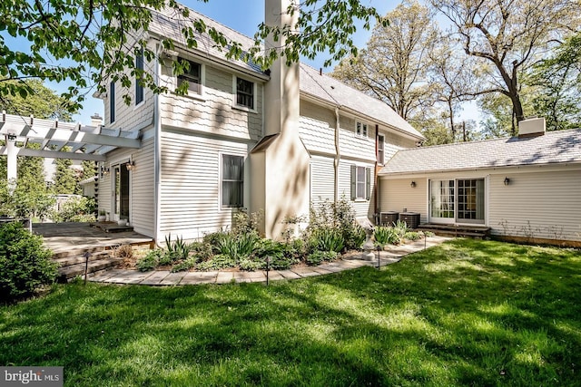 213 Pine Tree Rd, Wayne, PA 19087 - rear view of house featuring a pergola, a yard, a patio area, and a chimney
