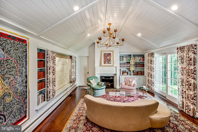 213 Pine Tree Rd, Wayne, PA 19087 - sitting room featuring wood finished floors, a chandelier, lofted ceiling, a fireplace, and a baseboard heating unit