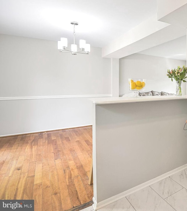 13059 Open Hearth Way, Germantown, MD 20874 - unfurnished dining area featuring baseboards and an inviting chandelier