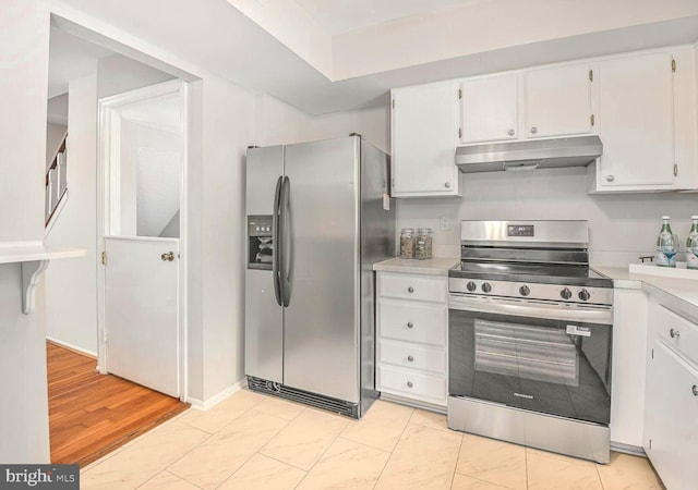 13059 Open Hearth Way, Germantown, MD 20874 - kitchen with appliances with stainless steel finishes, light countertops, white cabinetry, baseboards, and under cabinet range hood