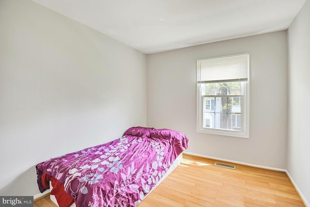 13059 Open Hearth Way, Germantown, MD 20874 - bedroom featuring baseboards, wood finished floors, and visible vents