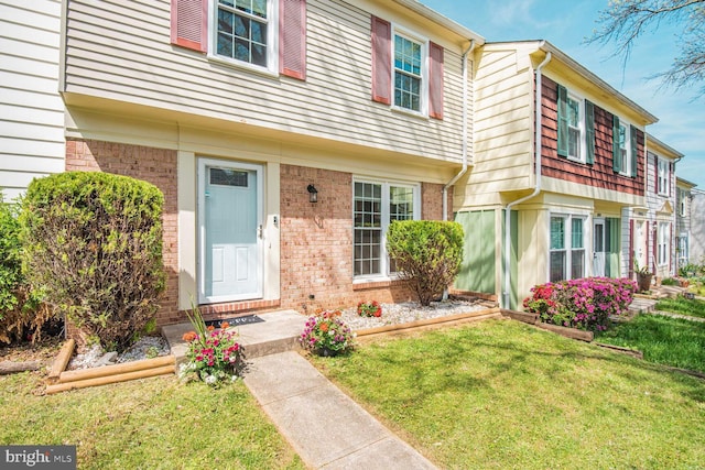 13059 Open Hearth Way, Germantown, MD 20874 - view of exterior entry featuring a yard and brick siding