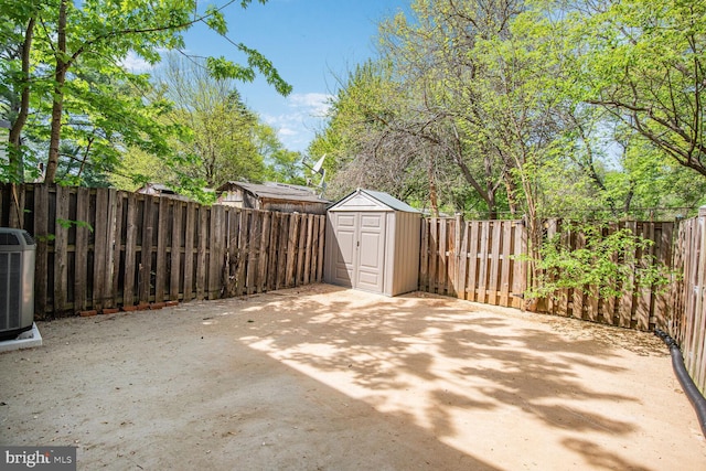 13059 Open Hearth Way, Germantown, MD 20874 - view of patio featuring cooling unit, an outbuilding, a fenced backyard, and a storage unit