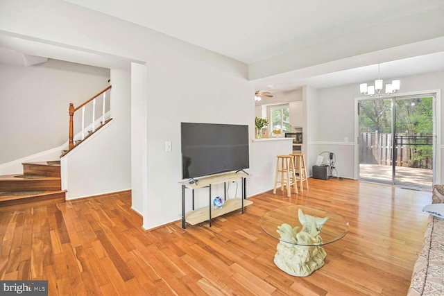 13059 Open Hearth Way, Germantown, MD 20874 - living area featuring an inviting chandelier, stairs, and wood finished floors