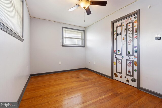 spare room with light wood-style flooring, baseboards, and ceiling fan