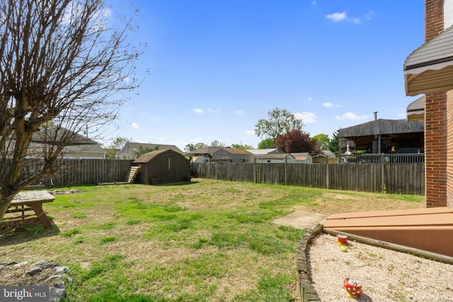view of yard featuring an outbuilding, a shed, and a fenced backyard