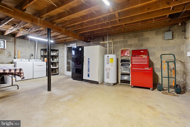 unfinished basement with water heater, freestanding refrigerator, and independent washer and dryer