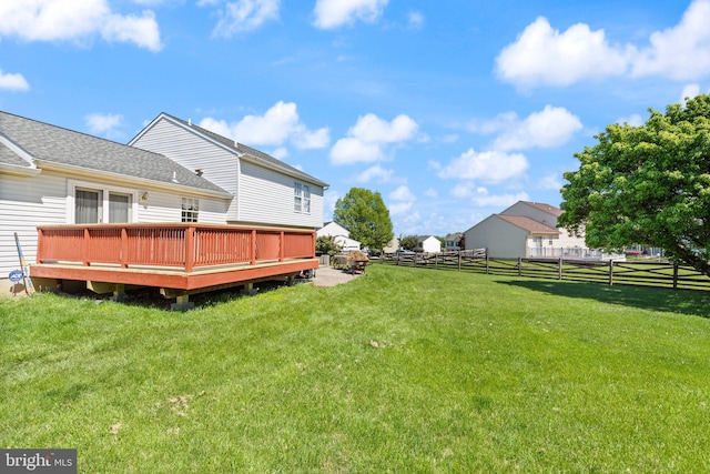 view of yard with fence and a wooden deck