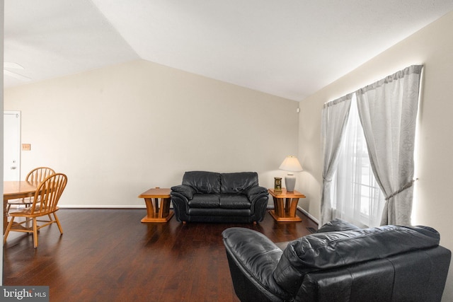 living room with baseboards, vaulted ceiling, and wood finished floors