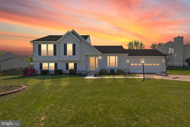 tri-level home with a yard, an attached garage, and driveway