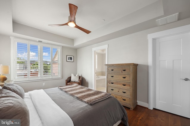 1353 Powhatan St, Alexandria, VA 22314 - bedroom with dark wood-type flooring, a tray ceiling, baseboards, connected bathroom, and a ceiling fan