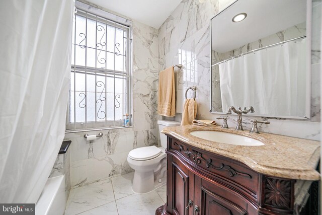 4517 Springfield Ave, Philadelphia, PA 19143 - full bath with marble finish floor, vanity, tile walls, and toilet