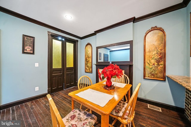 4517 Springfield Ave, Philadelphia, PA 19143 - dining area featuring visible vents, baseboards, ornamental molding, and dark wood-style floors