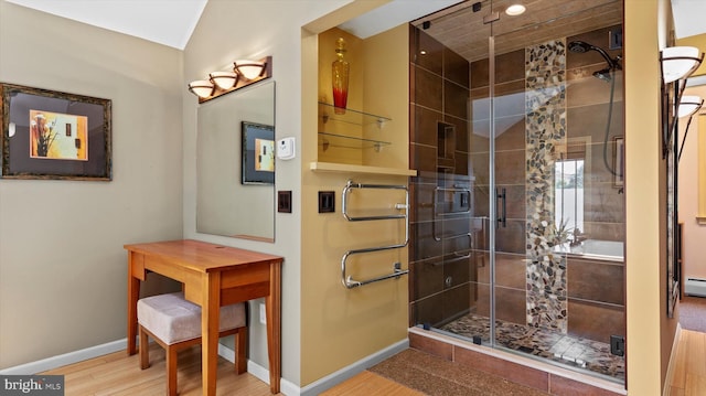 307 Homestead Rd, Hershey, PA 17033 - bathroom featuring a baseboard heating unit, baseboards, wood finished floors, and a stall shower