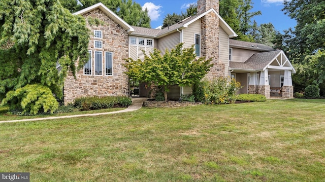 307 Homestead Rd, Hershey, PA 17033 - craftsman house featuring stone siding, a shingled roof, a chimney, and a front yard