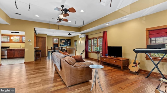 307 Homestead Rd, Hershey, PA 17033 - living area featuring baseboards, an AC wall unit, and light wood-style floors