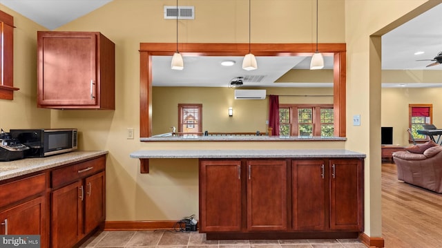 307 Homestead Rd, Hershey, PA 17033 - kitchen featuring visible vents, an AC wall unit, decorative light fixtures, baseboards, and ceiling fan