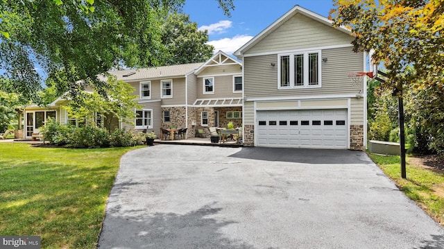 307 Homestead Rd, Hershey, PA 17033 - view of front facade featuring an attached garage, driveway, stone siding, and a front yard