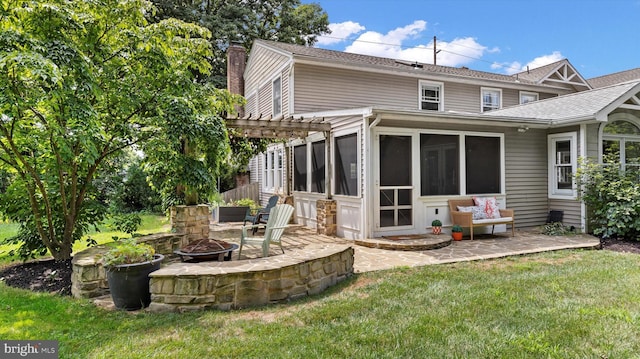 307 Homestead Rd, Hershey, PA 17033 - back of property featuring a chimney, a lawn, a sunroom, a patio, and an outdoor fire pit