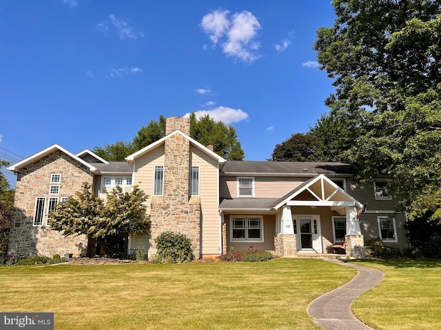 307 Homestead Rd, Hershey, PA 17033 - view of front of home with a chimney, stone siding, and a front yard