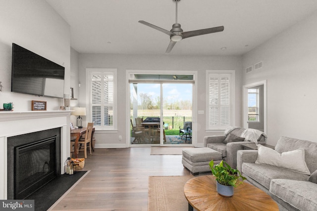 2537 Monarch Way, Bel Air, MD 21015 - living room featuring wood finished floors, a glass covered fireplace, ceiling fan, and baseboards
